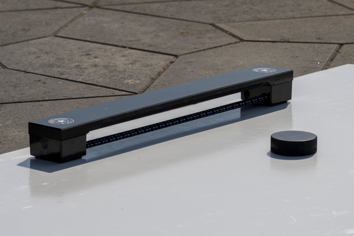 Hockey passare och puck på golvplatta, perfekt för träning av passningar och skott med Extreme Hockey Flooring Kit.